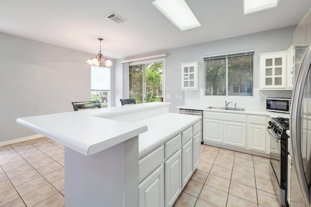 113 Stetson Trl, Georgetown, TX 78633 - kitchen featuring stainless steel appliances, light tile patterned flooring, white cabinetry, light countertops, and a chandelier