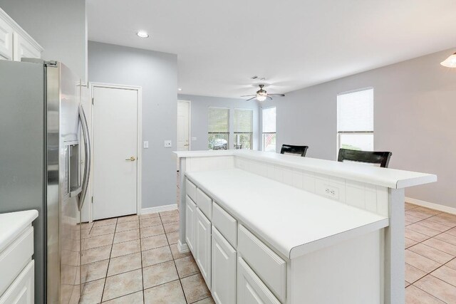 113 Stetson Trl, Georgetown, TX 78633 - kitchen with stainless steel fridge with ice dispenser, white cabinets, light tile patterned flooring, recessed lighting, and a ceiling fan