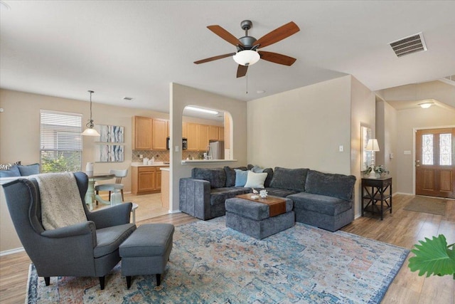 2818 Shadowpoint Cv, Round Rock, TX 78665 - living room featuring light wood-style flooring, ceiling fan, and arched walkways