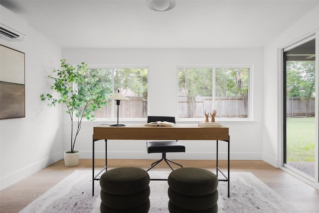11707 Barrington Way, Austin, TX 78759 - office area with plenty of natural light, a wall unit AC, and wood finished floors