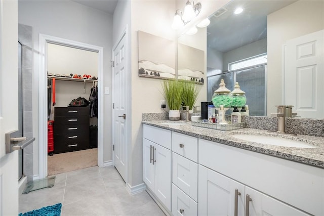540 Appalachian Trl, Leander, TX 78641 - full bathroom with double vanity, a stall shower, a spacious closet, and tile patterned floors