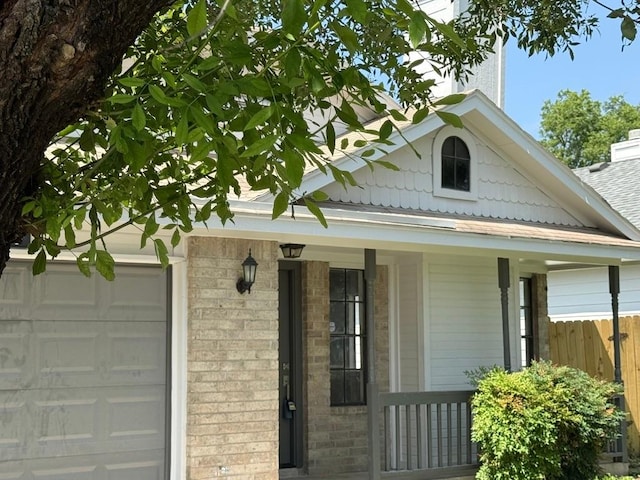 1903 Golden Pheasant Dr, Austin, TX 78758 - view of front of property with a porch, brick siding, and an attached garage
