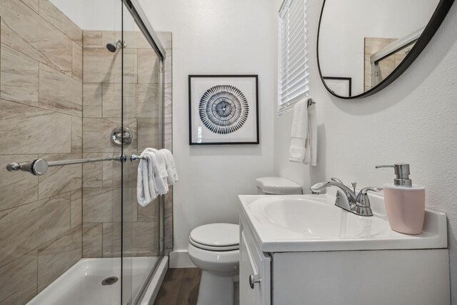 3405 Cedar St, Austin, TX 78705 - full bathroom with a shower stall, vanity, and wood finished floors