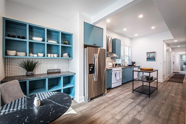 3405 Cedar St, Austin, TX 78705 - kitchen with stainless steel refrigerator with ice dispenser, gas range gas stove, blue cabinetry, tasteful backsplash, and recessed lighting