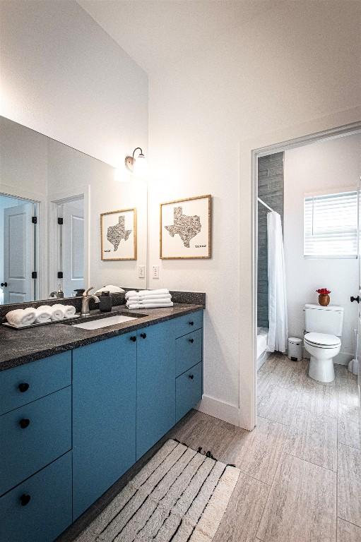 3405 Cedar St, Austin, TX 78705 - full bathroom with double vanity, wood finished floors, and shower / bath combo