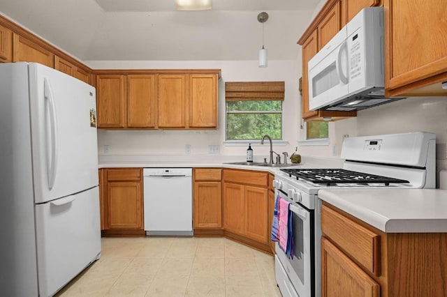 1831 Greening Way, Leander, TX 78641 - kitchen with white appliances, light countertops, brown cabinetry, and hanging light fixtures