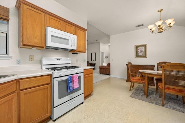 1831 Greening Way, Leander, TX 78641 - kitchen featuring white appliances, a chandelier, light countertops, brown cabinetry, and decorative light fixtures