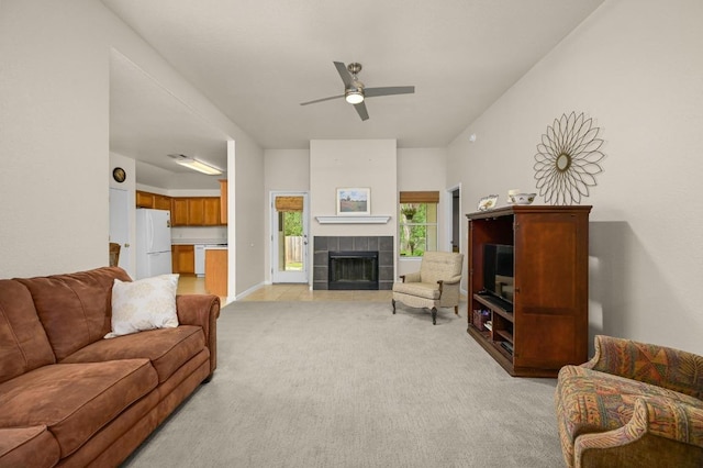 1831 Greening Way, Leander, TX 78641 - living area featuring light carpet, a ceiling fan, and a tiled fireplace