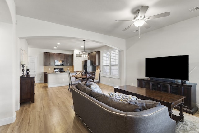 11400 W Parmer Ln Unit 4, Cedar Park, TX 78613 - living area featuring arched walkways, light wood finished floors, ceiling fan, and recessed lighting