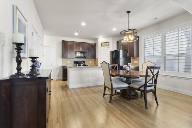 11400 W Parmer Ln Unit 4, Cedar Park, TX 78613 - dining area featuring light wood-style floors, arched walkways, recessed lighting, and a chandelier