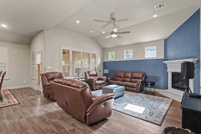 413 Fair Oaks Dr, Georgetown, TX 78628 - living room with a ceiling fan, a glass covered fireplace, lofted ceiling, recessed lighting, and wood finished floors