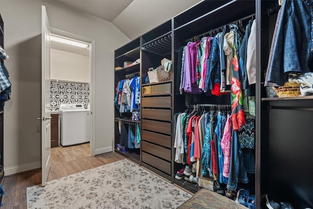 413 Fair Oaks Dr, Georgetown, TX 78628 - walk in closet with washer / clothes dryer, wood finished floors, and vaulted ceiling