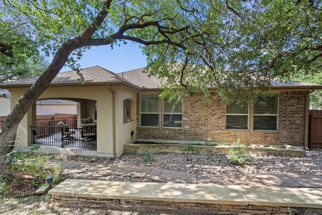 413 Fair Oaks Dr, Georgetown, TX 78628 - ranch-style house featuring brick siding, stucco siding, a patio, and roof with shingles