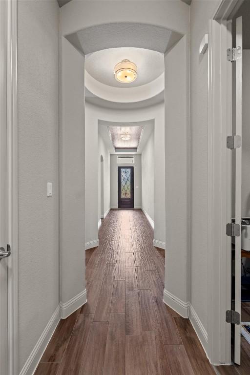 413 Fair Oaks Dr, Georgetown, TX 78628 - hallway featuring dark wood-style floors and a raised ceiling