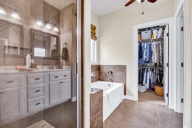 2207 Stonehaven, San Marcos, TX 78666 - full bathroom with a ceiling fan, a bath, tile patterned flooring, a spacious closet, and vanity