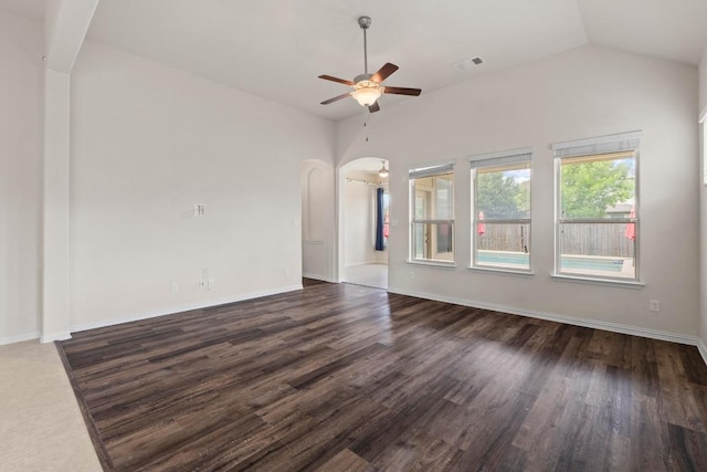 6042 Roma St, Round Rock, TX 78665 - unfurnished living room featuring ceiling fan, arched walkways, dark wood-style flooring, and vaulted ceiling