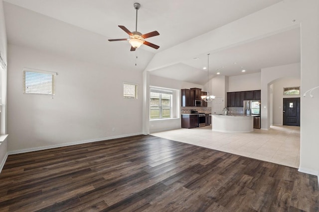 6042 Roma St, Round Rock, TX 78665 - unfurnished living room featuring light wood finished floors, ceiling fan, a chandelier, high vaulted ceiling, and recessed lighting