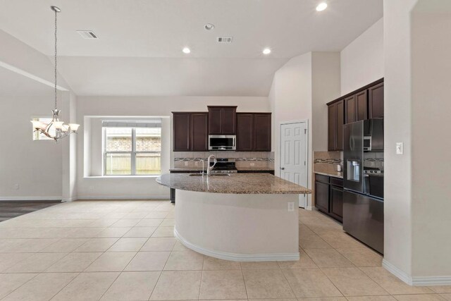 6042 Roma St, Round Rock, TX 78665 - kitchen featuring stainless steel appliances, lofted ceiling, decorative backsplash, light stone counters, and a chandelier