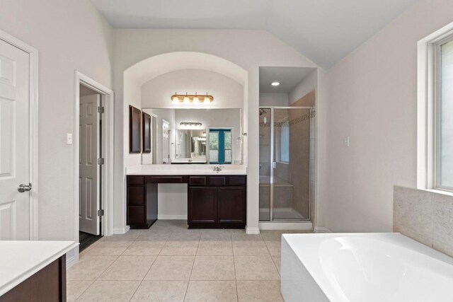 6042 Roma St, Round Rock, TX 78665 - bathroom with vanity, a stall shower, a bath, tile patterned flooring, and lofted ceiling