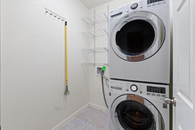 6042 Roma St, Round Rock, TX 78665 - laundry area with stacked washer / dryer and light tile patterned flooring