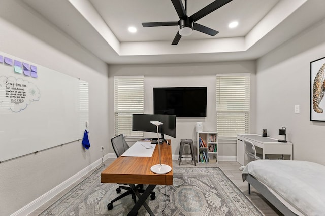 904 Astoria St, Cedar Park, TX 78613 - bedroom featuring a desk, a tray ceiling, and wood finished floors