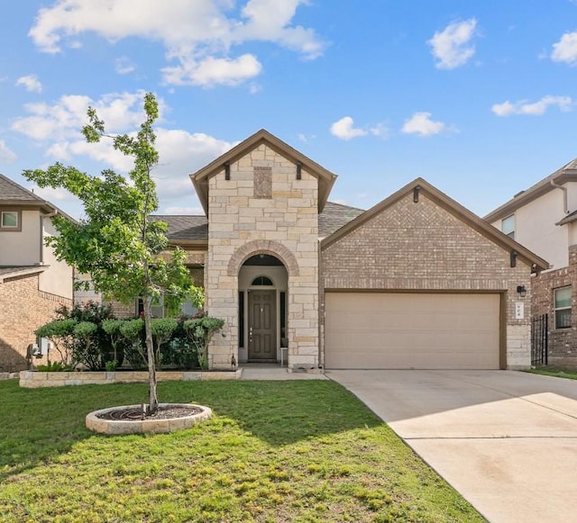904 Astoria St, Cedar Park, TX 78613 - french provincial home with a garage, concrete driveway, a front yard, and stone siding