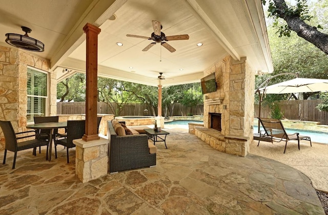 7108 Magenta Ln, Austin, TX 78739 - fenced backyard featuring an in-ground hot tub, an outdoor stone fireplace, a patio area, and a ceiling fan