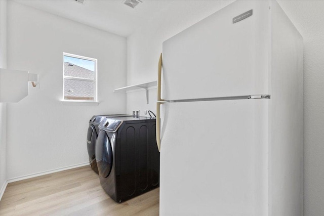 204 S Meadowlark St, Lakeway, TX 78734 - washroom with independent washer and dryer and light wood-type flooring