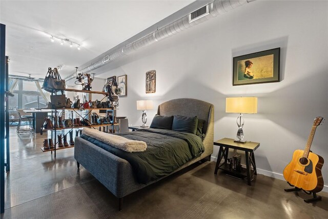 2124 E 6th St Unit 319, Austin, TX 78702 - bedroom featuring finished concrete floors and rail lighting