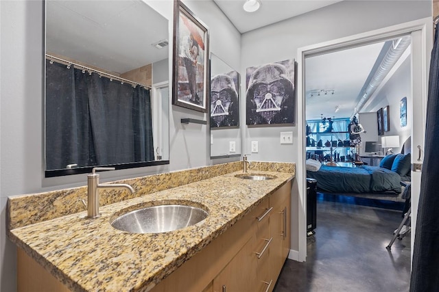 2124 E 6th St Unit 319, Austin, TX 78702 - ensuite bathroom with finished concrete floors and double vanity