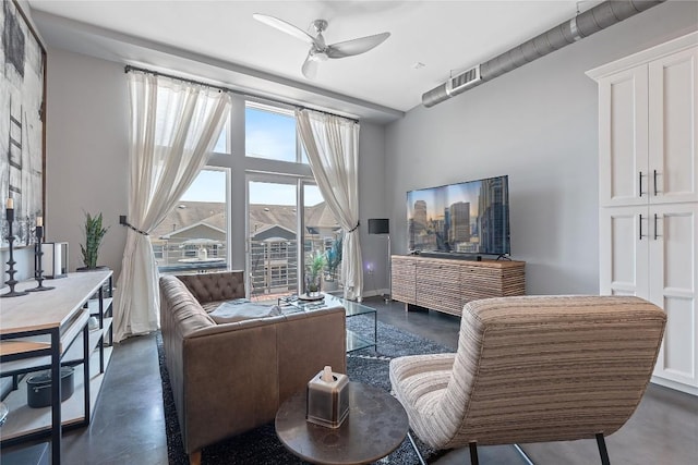 2124 E 6th St Unit 319, Austin, TX 78702 - living room with finished concrete floors and ceiling fan
