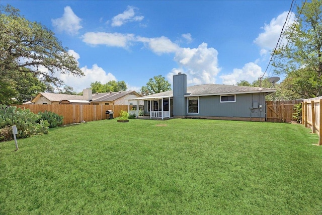 4910 Wing Rd, Austin, TX 78749 - back of property featuring a sunroom, a fenced backyard, and a chimney