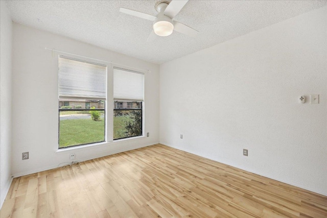 4910 Wing Rd, Austin, TX 78749 - empty room featuring light wood finished floors, a textured ceiling, and a ceiling fan