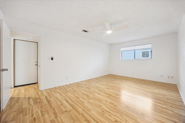 4910 Wing Rd, Austin, TX 78749 - empty room with light wood-style floors, ceiling fan, and a textured ceiling
