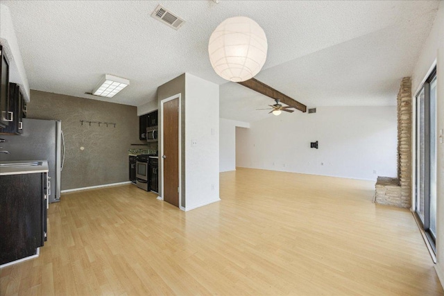 4910 Wing Rd, Austin, TX 78749 - kitchen featuring light wood finished floors, stainless steel appliances, a ceiling fan, dark cabinetry, and a textured ceiling