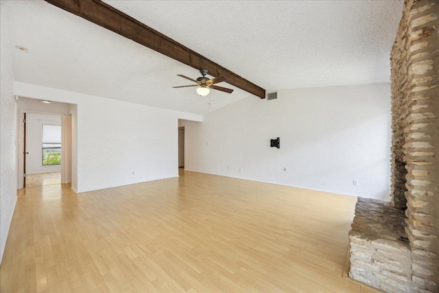 4910 Wing Rd, Austin, TX 78749 - unfurnished living room featuring light wood-style flooring, a ceiling fan, and a textured ceiling