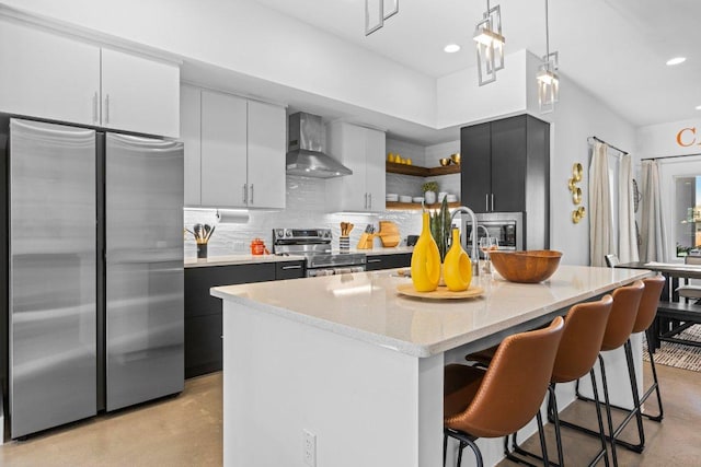 1305 Laurel Cv, Marble Falls, TX 78654 - kitchen featuring stainless steel appliances, wall chimney range hood, open shelves, finished concrete flooring, and a breakfast bar