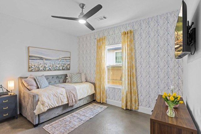 1305 Laurel Cv, Marble Falls, TX 78654 - bedroom featuring finished concrete floors, ceiling fan, and wallpapered walls