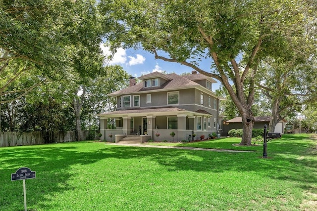 1004 Mitchell St, Gonzales, TX 78629 - american foursquare style home with a porch, stucco siding, and a chimney