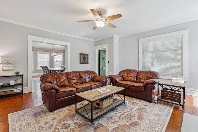 1004 Mitchell St, Gonzales, TX 78629 - living room featuring wood finished floors, ceiling fan, ornamental molding, and a chandelier