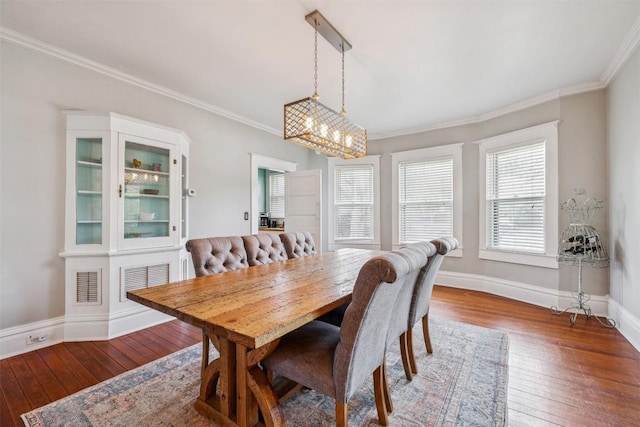 1004 Mitchell St, Gonzales, TX 78629 - dining room featuring ornamental molding, hardwood / wood-style flooring, and a chandelier