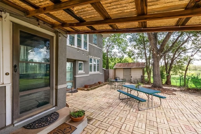 1004 Mitchell St, Gonzales, TX 78629 - view of patio / terrace featuring outdoor dining area and a storage shed