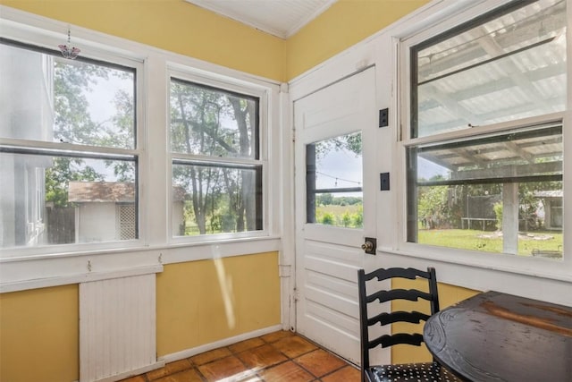 1004 Mitchell St, Gonzales, TX 78629 - doorway to outside featuring tile patterned floors and crown molding