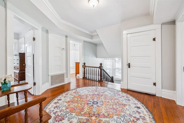 1004 Mitchell St, Gonzales, TX 78629 - living area with an upstairs landing, hardwood / wood-style flooring, crown molding, and a tray ceiling