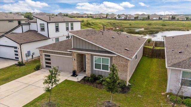 13716 Clerk St, Pflugerville, TX 78660 - view of front of property with a shingled roof, a residential view, brick siding, and board and batten siding