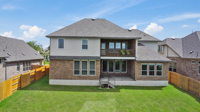 2233 Bellisa Vista Dr, Leander, TX 78641 - back of house with brick siding, roof with shingles, a fenced backyard, and a balcony