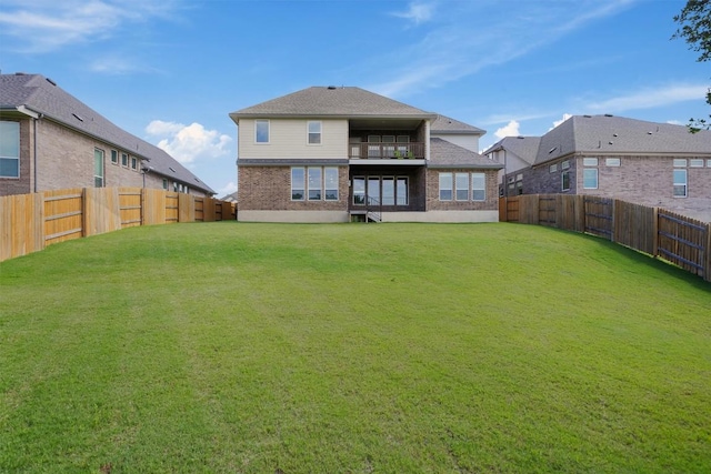 2233 Bellisa Vista Dr, Leander, TX 78641 - back of property with a balcony, a fenced backyard, and brick siding