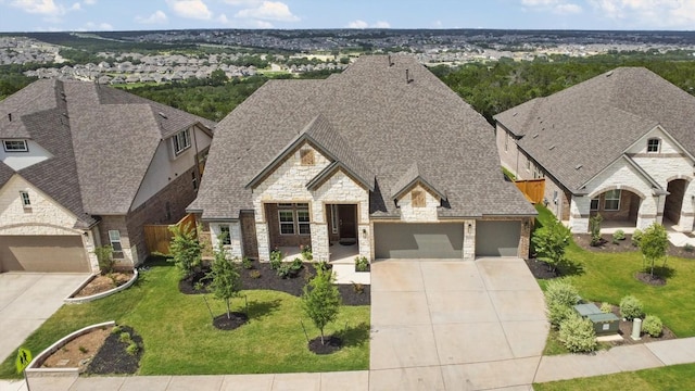 2233 Bellisa Vista Dr, Leander, TX 78641 - french country home featuring concrete driveway, stone siding, an attached garage, and a front yard