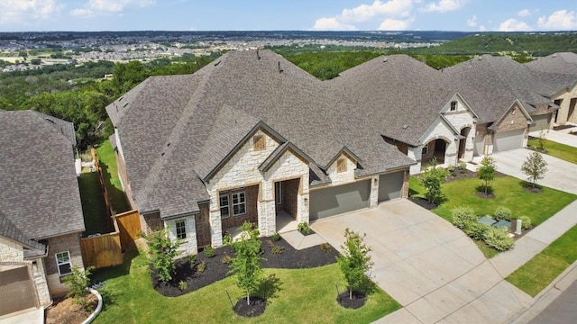 2233 Bellisa Vista Dr, Leander, TX 78641 - view of front of house with stone siding, concrete driveway, a garage, and a shingled roof