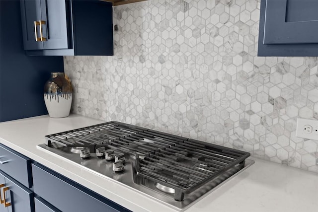 2233 Bellisa Vista Dr, Leander, TX 78641 - kitchen view of stainless steel gas stovetop, blue cabinets, and backsplash